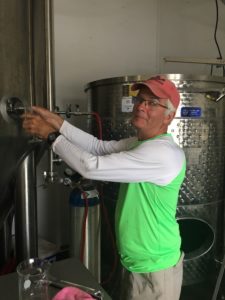 Colin Campbell tapping the cider tank - Apple Falls Cider Company