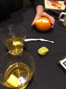 A slice of orange peal is squeezed into the Stone Fence cider cocktail 