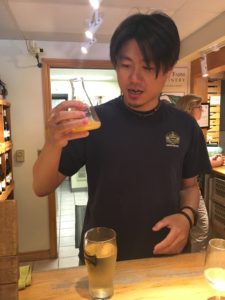 Richard Liu looking at glass of cider