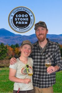 besty simpston and kyle doda of 1000 Stone Farm with cider in hand