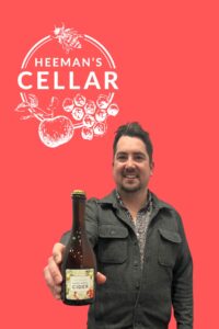 Tom Heeman of Heeman's Cellar in Ontario holding a bottle of cider episode 498 of Cider Chat