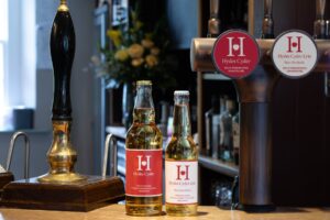 Hydes Cyder and Hydes Lyte alcohol-free cider displayed beside their draught taps at a pub in England.